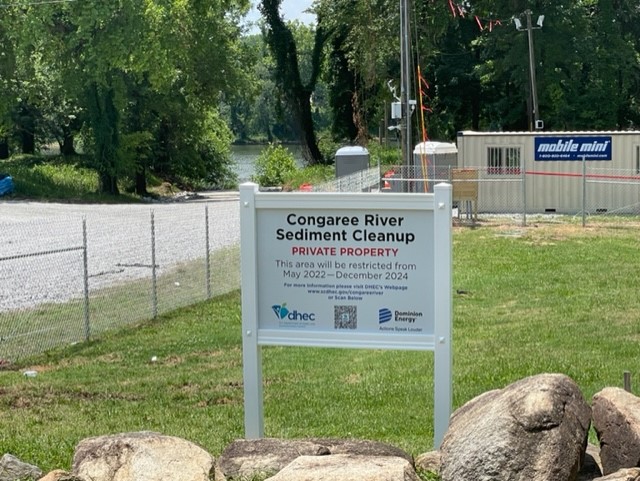 Sign with Partially Constructed Fence Behind