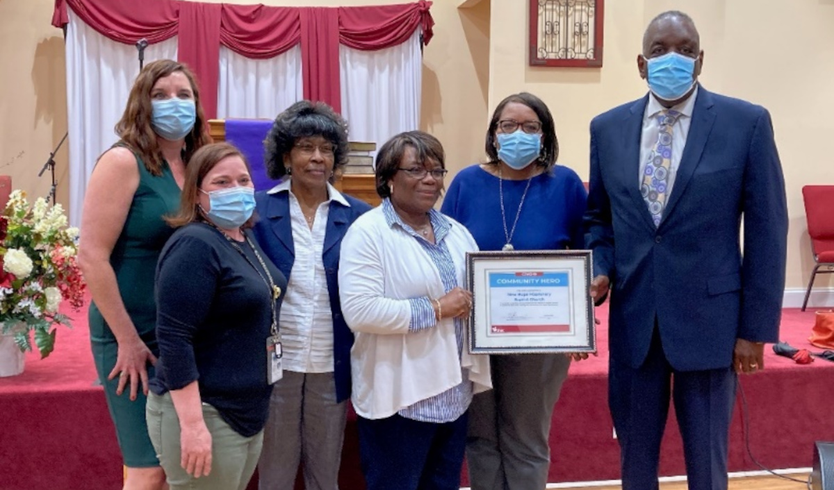 Six people standing with certificate