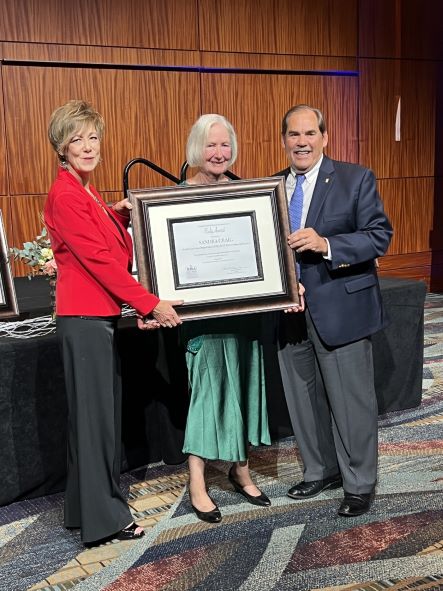 Sandra Craig (middle) wins 2022 Rudy Award