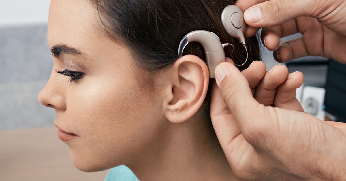 young female turned to the left being fit for a cochlear implant