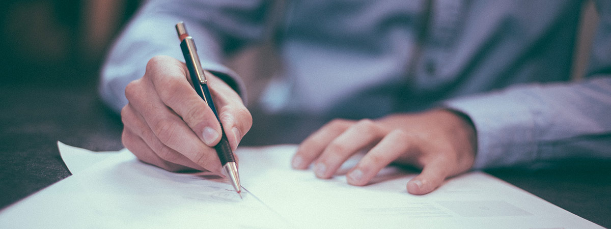 Man with pen writing 